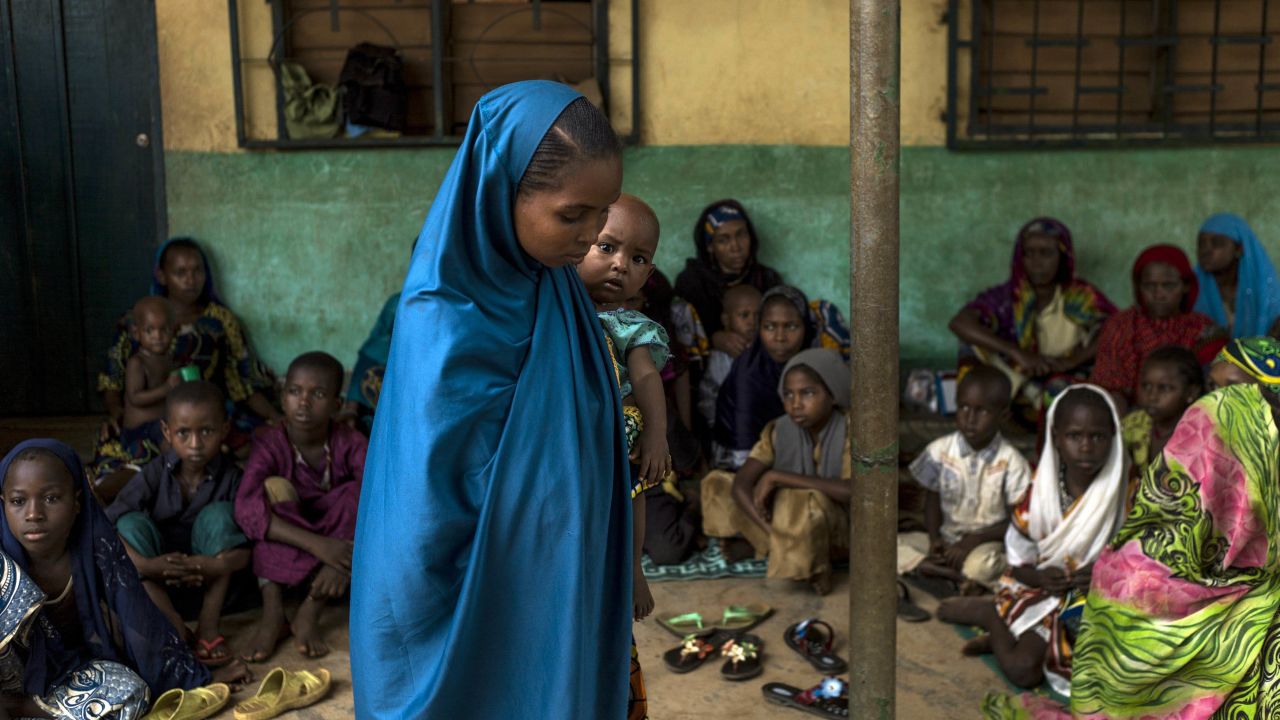 A young woman holds her baby at an elementary school in the Muslim district of Bangui on December 11.
