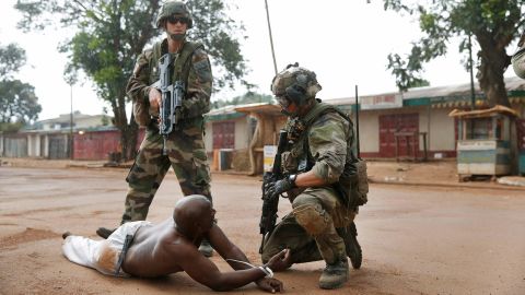 French troops detain a suspected Seleka officer -- preventing a Christian mob from lynching him -- in Bangui on Monday, December 9. The mission of the peacekeeping force is to protect civilians in the Central African Republic, restore humanitarian access and stabilize the country.