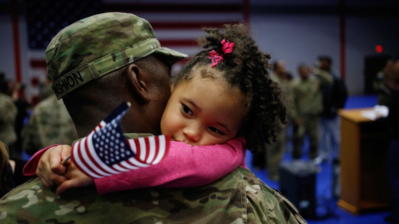Army Spc. Michael Fashion holds his daughter Malia, 5, upon his return home last month after a deployment in Afghanistan.
