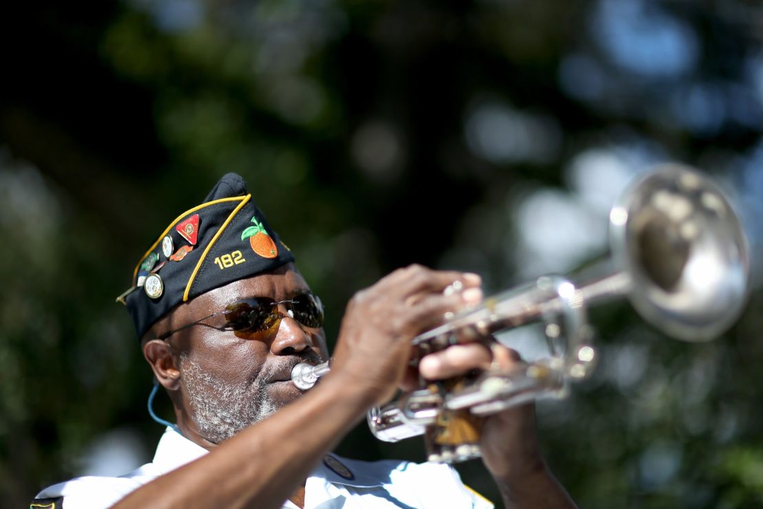 Cyril Bullard, retired from the U.S. Army, plays the trumpet at a Veterans Day ceremony last month in Florida.