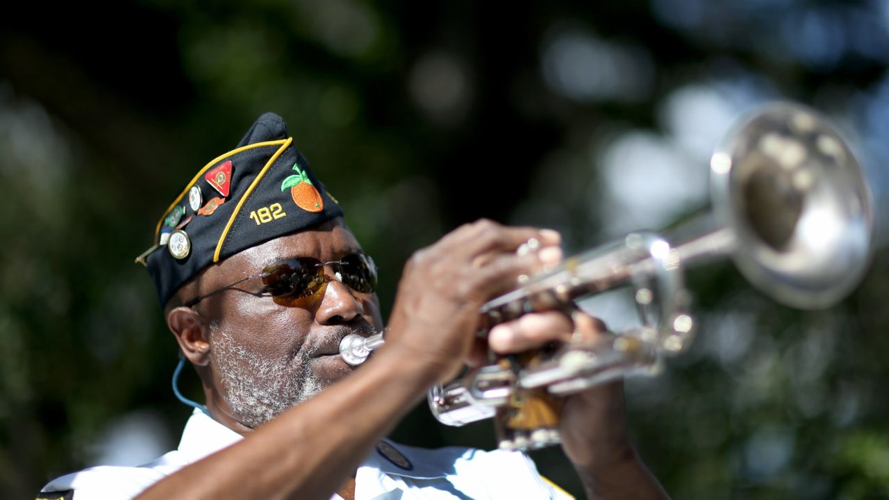 Cyril Bullard, retired from the U.S. Army, plays the trumpet at a Veterans Day ceremony last month in Florida.