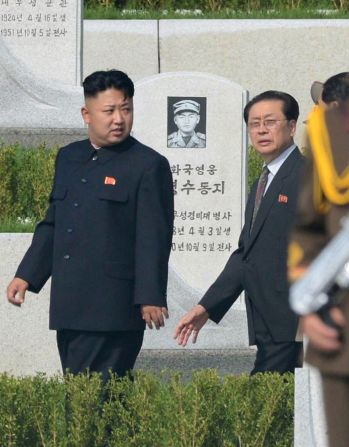 Kim Jong Un, left, and Jang Song Thaek walk through a cemetery for Korean War veterans on July 25 in Pyongyang, North Korea, marking the 60th anniversary of the signing of the armistice that ended hostilities on the Korean peninsula.