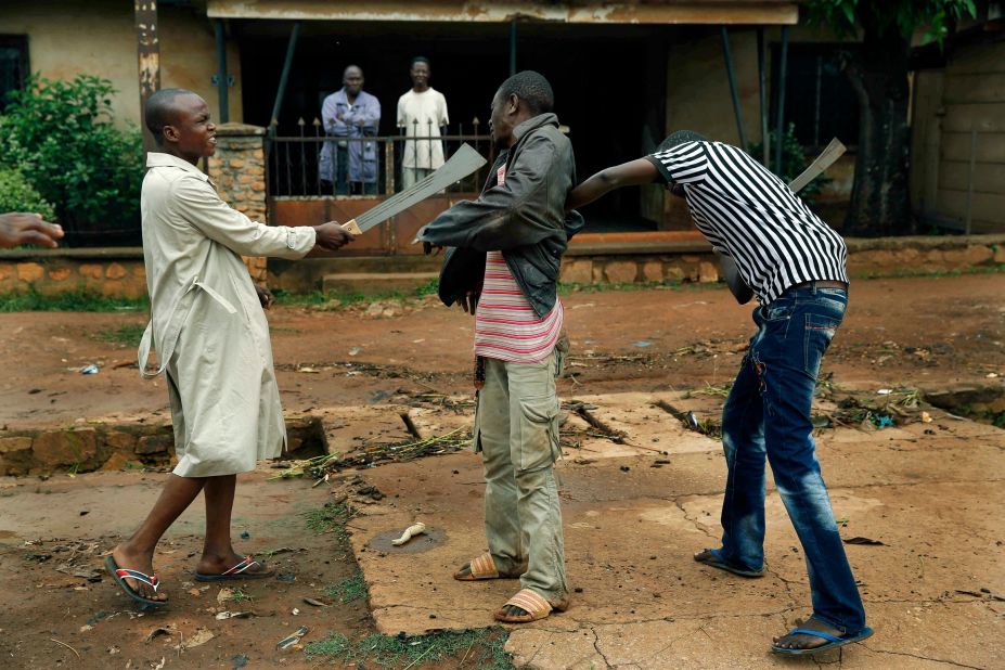 Muslim men rough up a Christian man while checking him for weapons December 13 in Bangui.