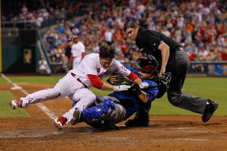 Chase Utley of the Philadelphia Phillies collides with Dioner Navarro of the Chicago Cubs on August 7 in Philadelphia.