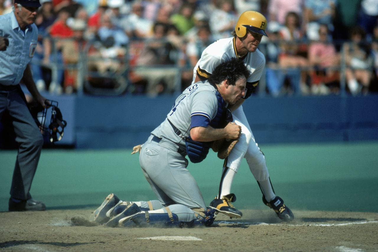 Catcher Mike Scioscia of the Los Angeles Dodgers collides with Joe Orsulak of the Pittsburgh Pirates as he crosses home plate during a 1985 season game in Pittsburgh.