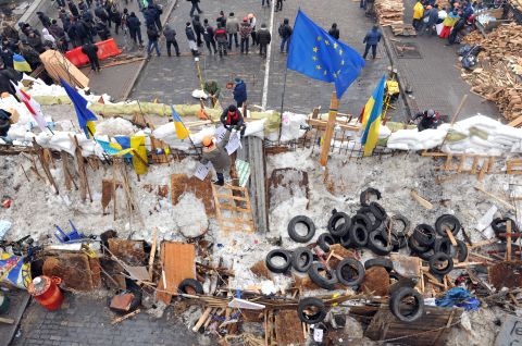 Protesters stand at a barricade in Kiev on December 13.