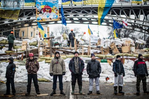 Anti-government protesters guard a barricade designed to keep police from evicting them from Independence Square on Friday, December 13.