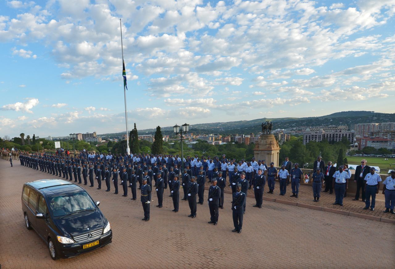 The hearse carrying former South African President Nelson Mandela leaves the Union Buildings after the final day of his lying in state in Pretoria, South Africa, on Friday, December 13.