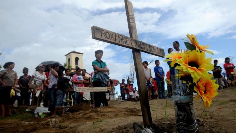 Relatives of the victims of Tyhpoon Haiyan attend a mass in Palo, Leyte on December 8, 2013.