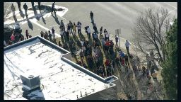 People gather outside the Arapahoe Highschool in Centennial, Colorado, on December 13.