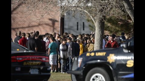 Students wait outside Arapahoe High school after being evacuated on December 13. 