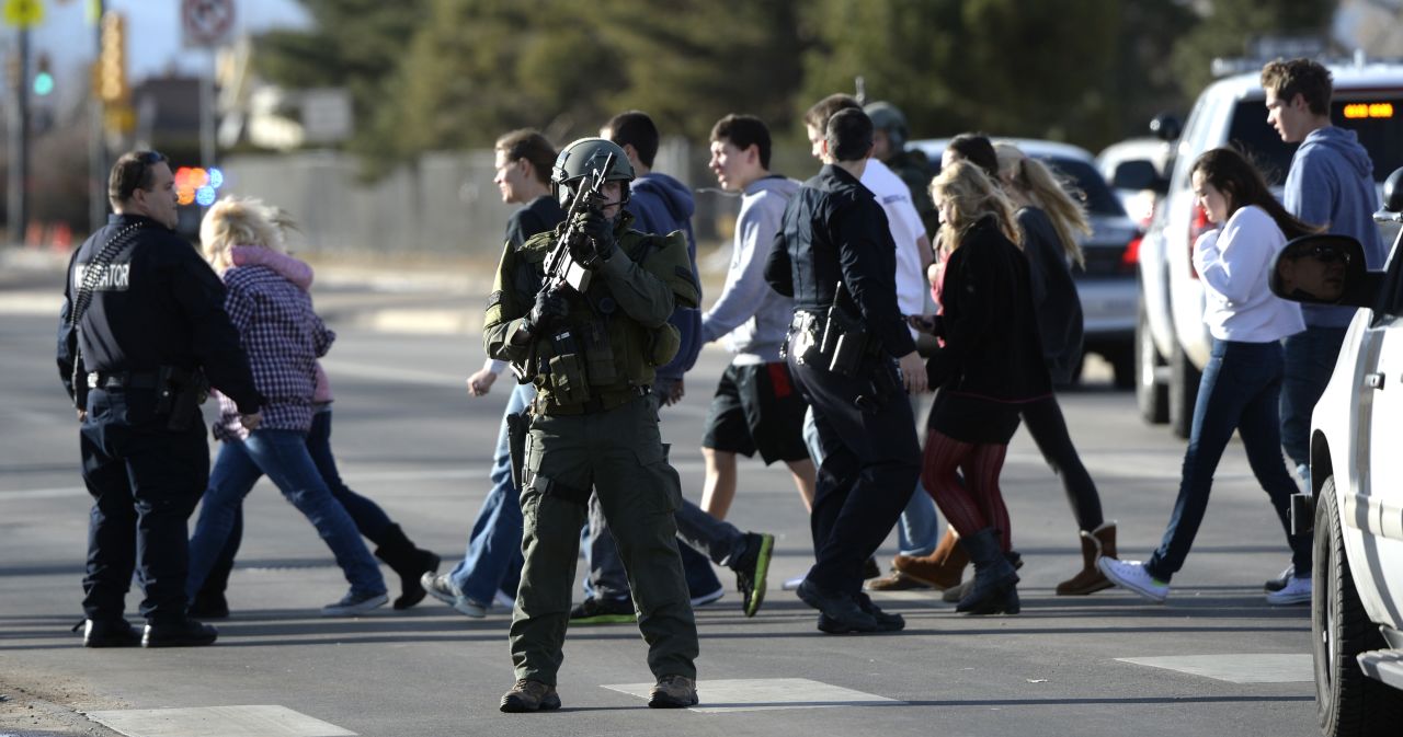 Officers escort students out of Arapahoe High School.