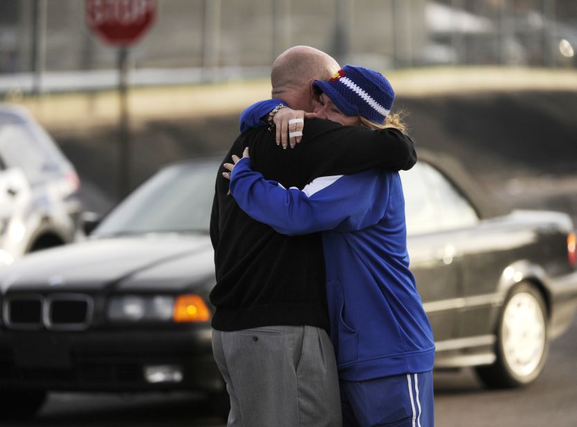 Susie Ohle hugs Rob Escue as he came out of the school on Friday afternoon.