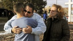 Ruben Allen hugs his son Alex Allen, 17, after being evacuated from the school