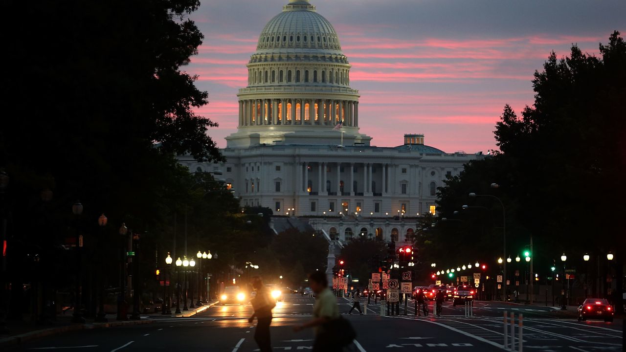 WASHINGTON, DC - OCTOBER 17: The sun begins to rise behind the U.S. Capitol building on the morning after a bipartisan bill was passed by the House and the Senate to reopened the government and raise the debt limit, on October 17, 2013 in Washington, DC. President Obama signed the bill into law, that will fund the government until January 15, 2014 and allow the government to pay bills until February 7, 2014.