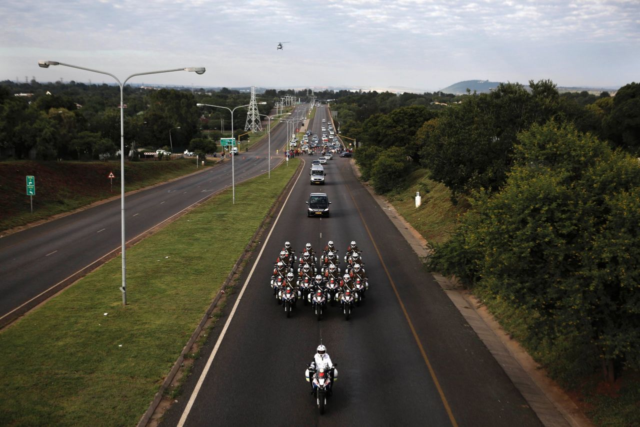 Motorcycles escort Mandela's hearse.