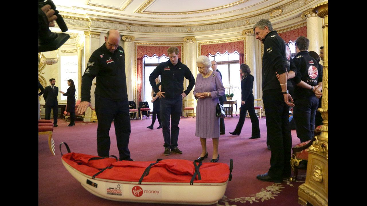 Ed Parker, left, co-founder of Walking With the Wounded and team mentor of Team USA, Prince Harry and Queen Elizabeth examine a pulk belonging to Team U.K. during a reception to meet the three teams of wounded servicemen and servicewomen.
