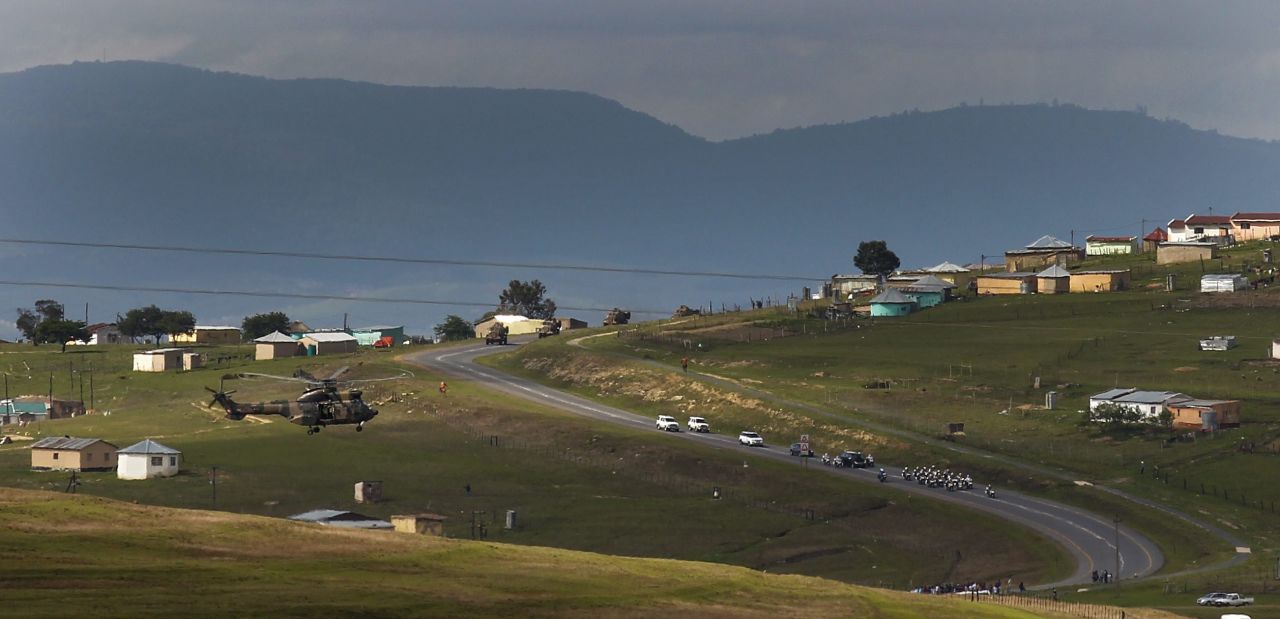 Mandela's coffin is taken in a motor cortege to his final burial place in his ancestral village of Qunu.