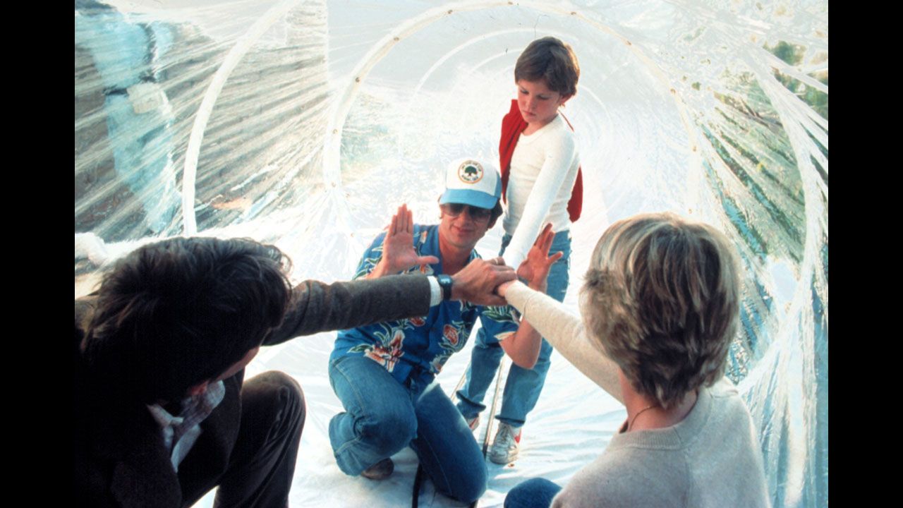 Spielberg, wearing a hat, works with actors Peter Coyote, Henry Thomas and Dee Wallace during the filming of "E.T.; The Extra-Terrestrial" in 1982. As of 2013, the movie had made more than $792 million worldwide.
