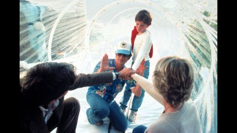 Spielberg, wearing a hat, works with actors Peter Coyote, Henry Thomas and Dee Wallace during the filming of "E.T.; The Extra-Terrestrial" in 1982. As of 2013, the movie had made more than $792 million worldwide.