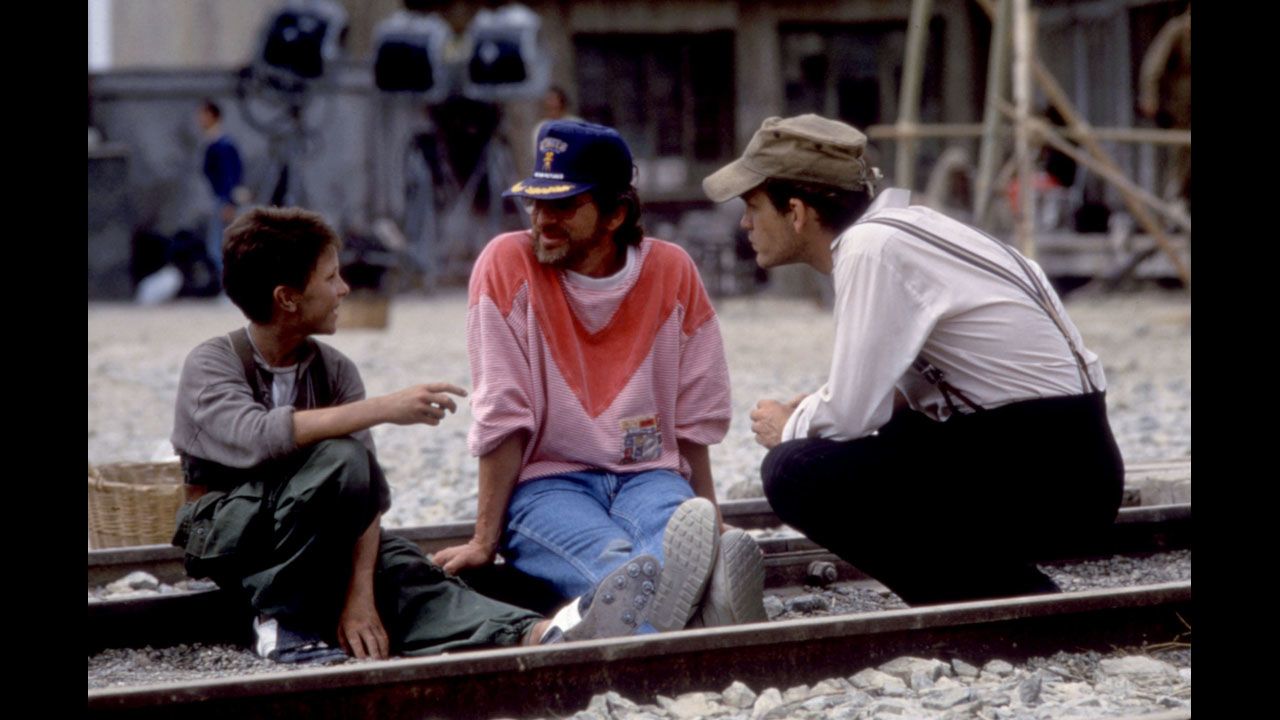 Actor Christian Bale, left, Spielberg and John Malkovich talk on the set of "Empire of the Sun" in 1987. The film is taken from J.G. Ballard's novel based on Ballard's experiences as a boy in a Japanese prison camp during World War II. 