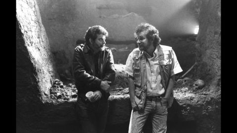Executive producer George Lucas, left, and Spielberg confer on the set of the film "Indiana Jones and the Last Crusade" in 1989. The two influential filmmakers have worked on multiple movies together.