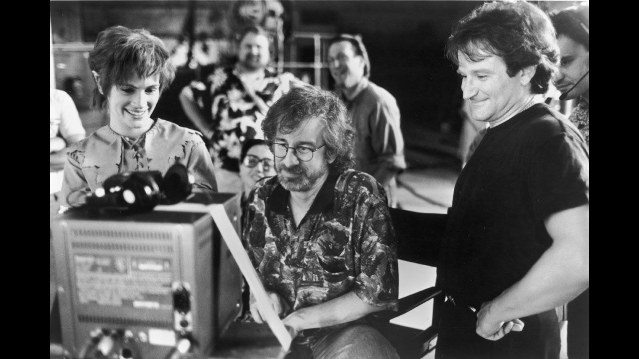 Actors Julia Roberts and Robin Williams watch production footage with Spielberg on the set of the film "Hook" in 1991.