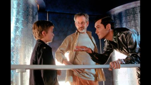 Actor Haley Joel Osment, left, Spielberg and Jude Law work on a scene from the movie "A.I. Artificial Intelligence" in 2001. The film is about a highly advanced robotic boy longing to become "real," a real sci-fi "Pinocchio" drama.