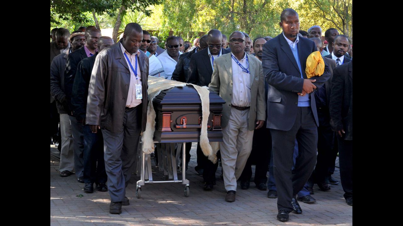 Nelson Mandela's grandson Mandla Mandela, center, leads local chiefs as they escort the lion-skin-draped casket of Mandela in Qunu on December 14.