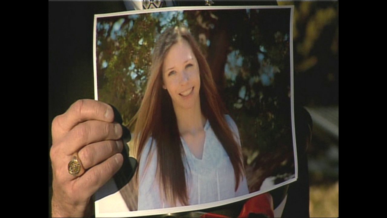 Arapahoe County Sheriff Grayson Robinson holds up a photograph of Claire Davis, a 17-year-old senior. who he identified as the girl was shot Friday at Arapahoe High School.