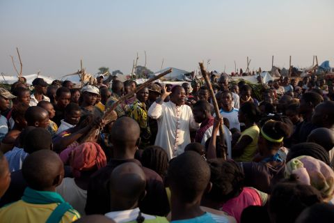 The Archbishop of Bangui, Dieu Donne Nzapa Lainga, preaches on Saturday, December 14, to people gathering at a refugee camp close to the Bangui airport.