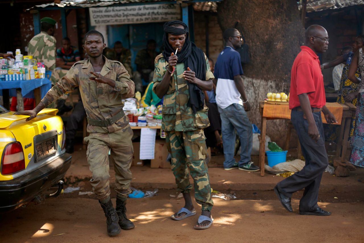 A Seleka presidential guardsman smokes at the downtown market in Bangui on December 14. 