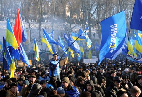 Supporters of the president wave flags of the ruling Party of Regions, as well as Ukrainian flags, during a rally on Kiev's European Square on December 14.
