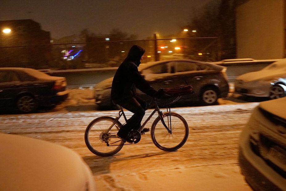 A person delivers food on a bike during a snowstorm in Brooklyn, New York, on December 14.
