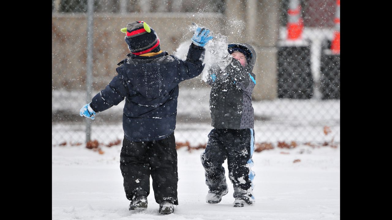 Landon Jackloski, left, and Patrick Craig engage in a snow fight on December 14 as snow falls during the tree-lighting ceremony at Forty Fort Park in Forty Fort, Pennsylvania.