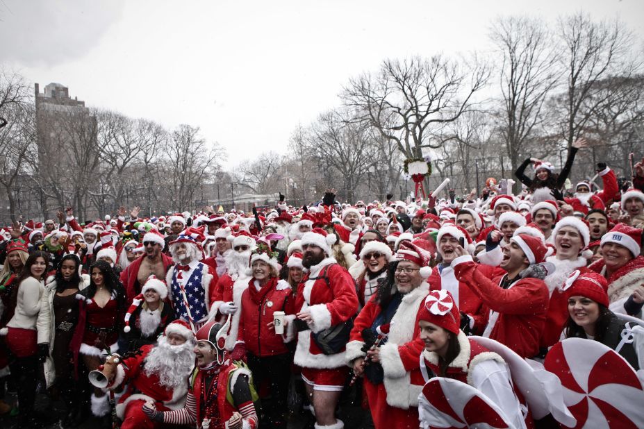 Revelers dressed as Santa Claus pose for a picture at Tompkins Square Park during the annual NYC SantaCon on Saturday, December 14, 2013.