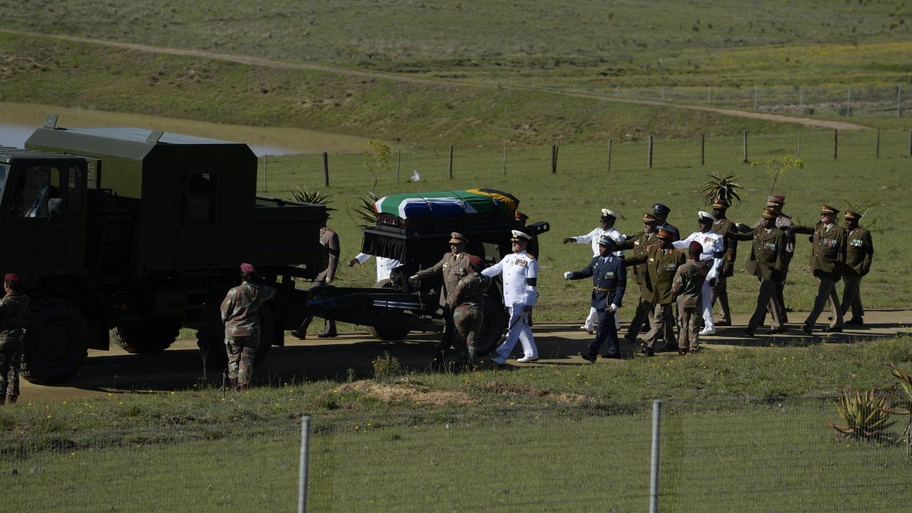 Mandela's casket is escorted to the funeral ceremony on December 15.