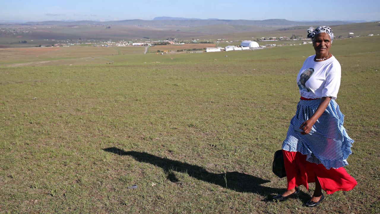 A woman walks on a hill overlooking the processional to Mandela's funeral service in Qunu on December 15.