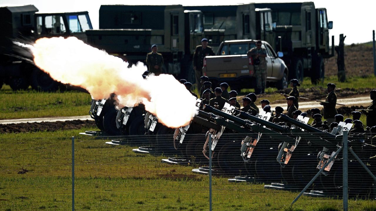 A 21-gun salute is fired as the funeral procession carrying the casket of Mandela moves through Qunu.
