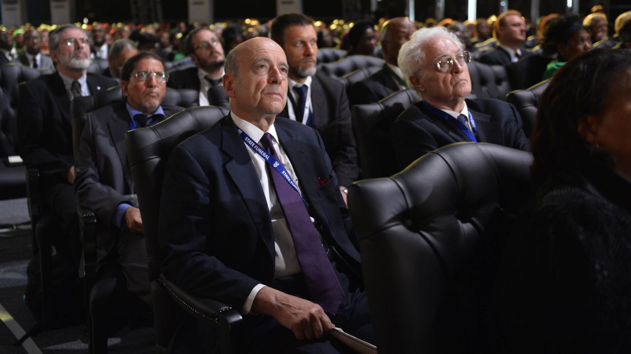 Former French Prime Ministers Alain Juppe, center, and Lionel Jospin, right, attend the funeral ceremony.
