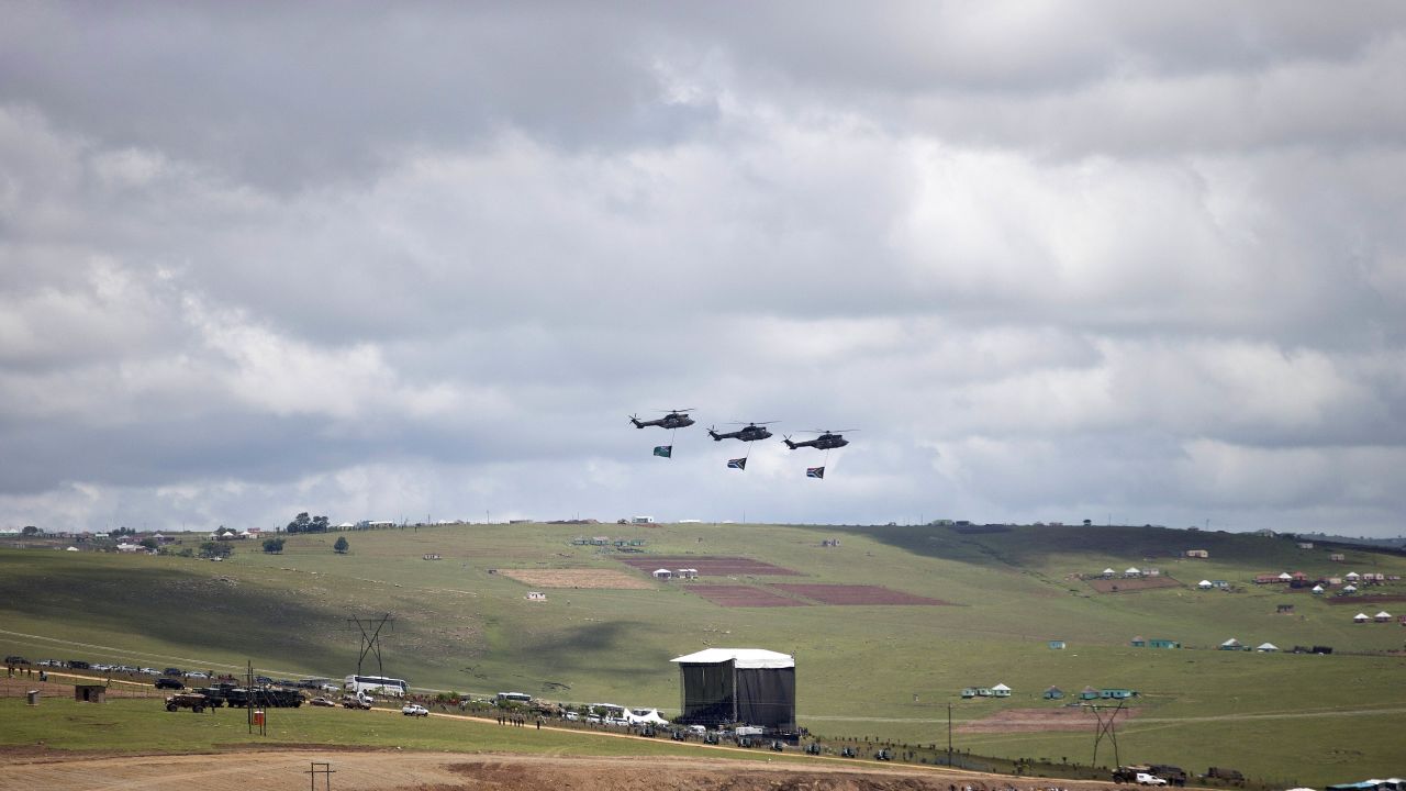 Three helicopters fly over the grave site of former South African President Nelson Mandela as his family lays his body to rest in his hometown of Qunu, South Africa, on Sunday December 15. Mandela's body traveled from Pretoria by air to Mthatha in Eastern Cape province, and then by road to Qunu, where was buried Sunday. Mandela died December 5 at his home in Houghton at the age of 95.