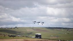 Three helicopters fly over the gravesite of Nelson Mandela as his family buries him in his hometown of Qunu, South Africa, on Sunday December 15.