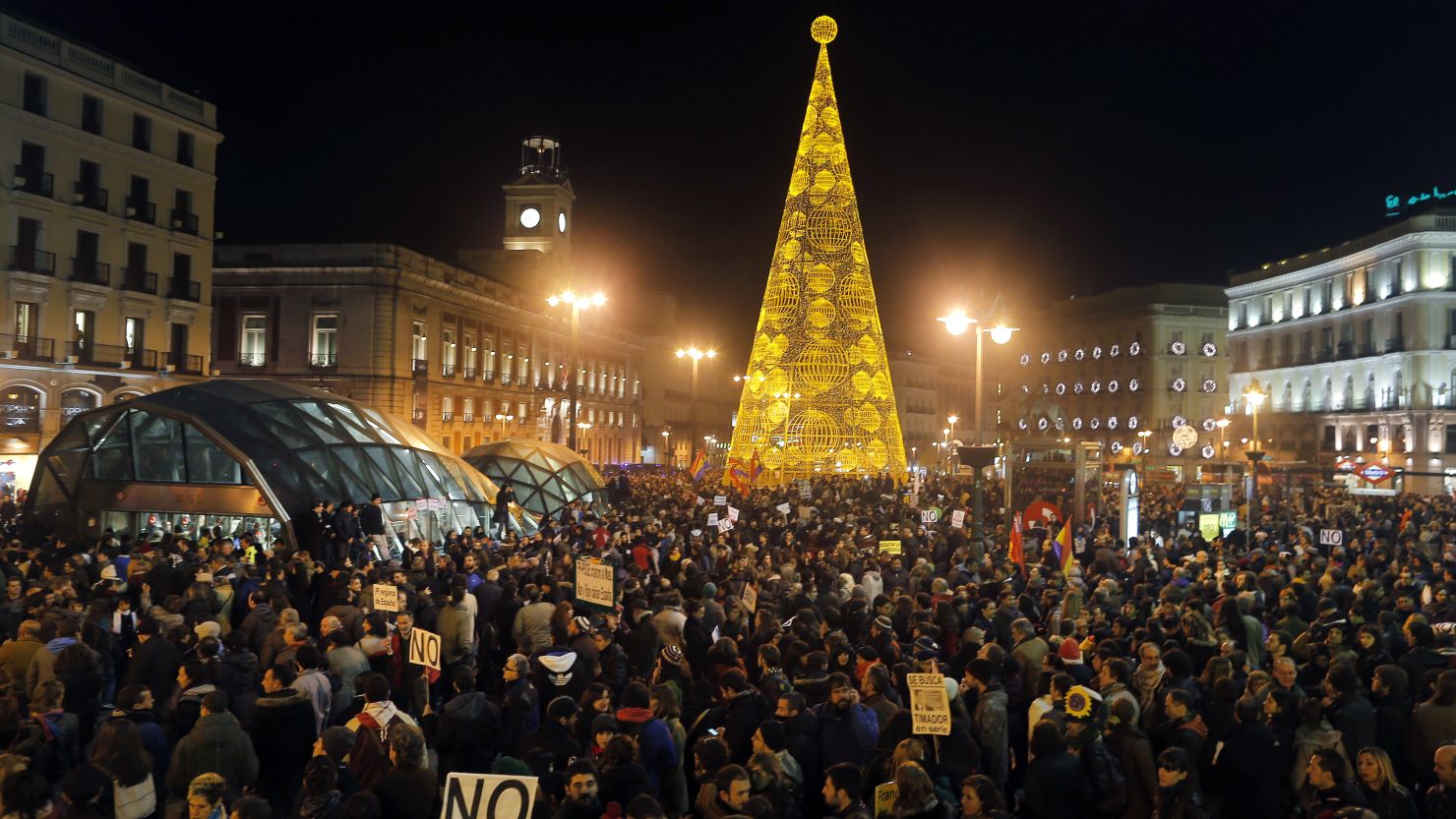 Protestors march through the city center during a demonstration against the government in Madrid on December 14, 2013.