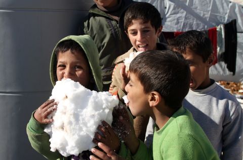 Syrian children play with snow in the Arsal refugee camp on December 15.