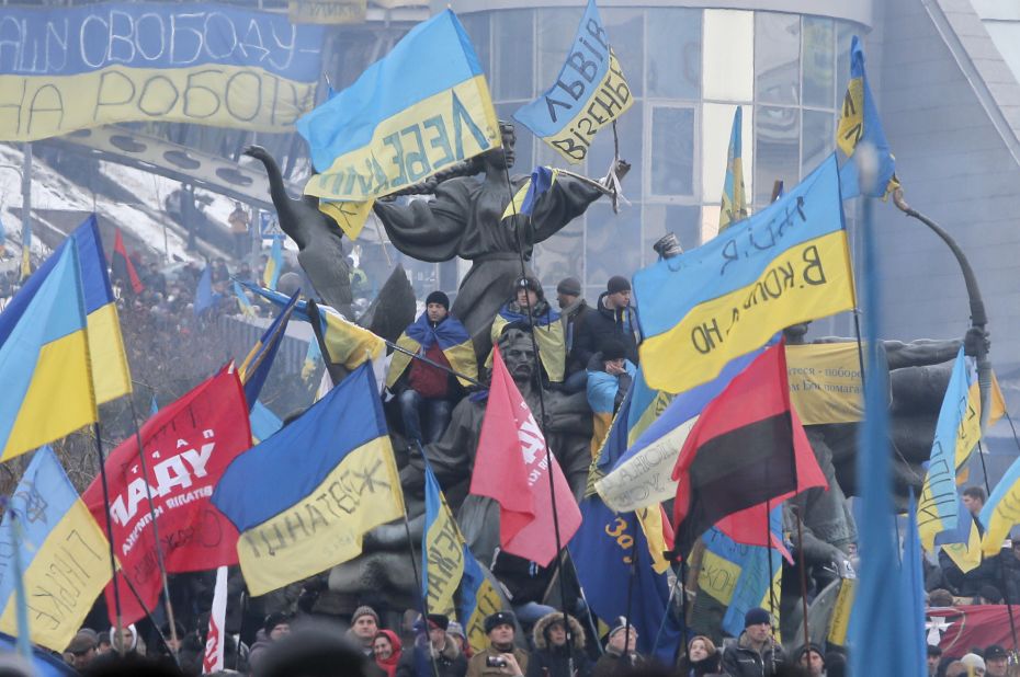 Pro-EU activists wave flags around the monument to the founders of Kiev during a rally in Independence Square on December 15.