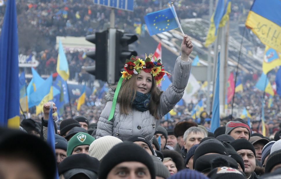 Pro-EU activists, one waving the EU flag, gather during a rally in Kiev on December 15.