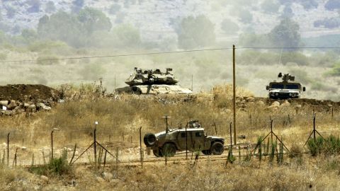 A picture taken from a Lebanese village in August shows Israeli troops on the border between Lebanon and Israel.