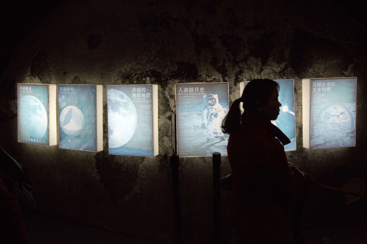 DECEMBER 16 - BEIJING, CHINA: A woman browses an exhibit about the moon at the China Science and Technology Museum in Beijing. <a href="http://edition.cnn.com/2013/12/14/world/asia/china-moon-landing/index.html?hpt=hp_c4">China's first moon rover touched down on Saturday</a>. The Jade Rabbit (called Yutu in Chinese) left deep traces on the lunar surface, as China became the third country in history to reach the moon.