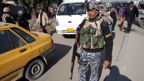 A member of the Iraqi security forces monitors a checkpoint in Baghdad on December 16, 2013. 