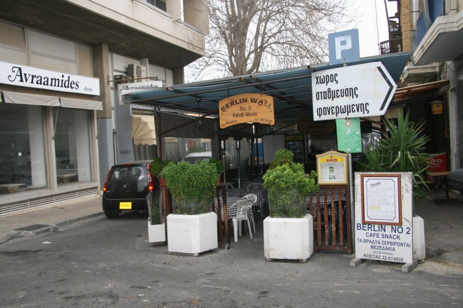 The kebab shop Berlin No 2 sits on a barricaded street on the south side of the city. Customers order beer and souvlaki beneath a sign that reads "Checkpoint Charlie". 